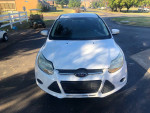 Front view of a white 2014 Ford Focus with minor damages and 63,000 miles on the odometer