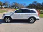 Side view of a 2011 Honda CR-V EX-L with 53,000 miles parked on a sunny day.