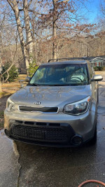 2014 Kia Soul in silver color parked outdoors, featuring minor scratches and a check engine light.