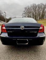 Rear view of a 2008 Buick LaCrosse CX in Imperial Blue, showcasing its sleek design and chrome accents.