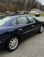 2008 Buick LaCrosse CX in Imperial Blue with chrome wheels, showing side view and detailed exterior.