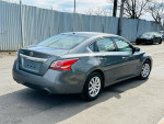 2015 Nissan Altima 2.5 S with clean title and rear view camera, parked on the street.