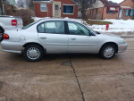 Silver Chevrolet sedan parked on the street, well-maintained and ready for highway driving.