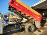 1993 GMC C3500 truck with dump bed, showing rust and engine condition.