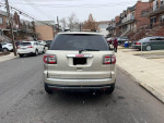 Rear view of a 2013 GMC Acadia SLE parked on a street, featuring all-wheel drive and clean title.