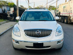 Front view of a 2011 Buick Enclave CXL2 with chrome grille and headlights, parked in an urban setting.