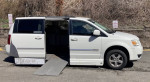 2009 Dodge Grand Caravan with side entry ramp for wheelchair access parked outdoors.