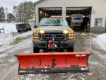 2000 Ford F250 Super Duty plow truck with Western Unimount plow parked in snowy driveway