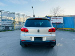 2015 Volkswagen Tiguan SE 4Motion AWD in silver, showcasing rear view with clean lines and no obstructions.