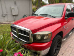 2008 Dodge RAM 1500 in red with LED upgrades and leather seats, parked outdoors.