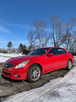 2010 Infiniti G37x AWD in bright red parked on snowy road, showcasing sporty design and clean appearance.