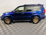 2008 Lexus GX 470 4WD in blue with new off-road wheels and all-terrain tires, showing excellent condition and mileage.