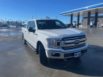 2018 Ford F-150 XLT truck at a gas station, featuring a clean exterior and new tires.