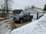 2005 GMC 2500 SLT Duramax in gray with Leather seats, parked in winter setting, showing snowy driveway.
