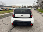 2016 Kia Soul with alloy wheels parked on the street, showcasing rear view and clean exterior.