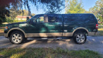 Green 2008 Ford F150 King Ranch 4x4 truck with clean title and low mileage parked on a sunny day.