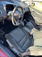 Interior view of a 2007 Honda Civic Si with manual transmission and worn seats.
