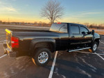 2012 Chevrolet Silverado 1500 LTZ 4WD truck parked in a lot at sunset, showcasing its long bed and clean appearance.