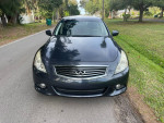Front view of a 2011 Infiniti G25 x parked on a residential street, showcasing its sleek design and clean condition.
