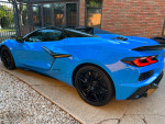 2023 Chevrolet Corvette Z06 in Rapid Blue with black accents, showcasing sleek design and low mileage.