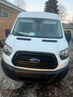2016 Ford Transit 350 Van in white, front view with a black grille, ideal for commercial use.