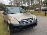 2006 Honda CR-V LX FWD parked on the street, well-maintained, clean exterior, ready for a road trip