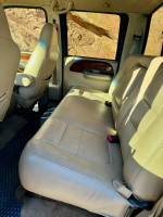 Interior view of a 2001 Ford F350 Super Duty Crew Cab with leather seats, showcasing spaciousness and comfort.