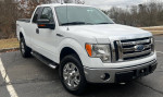 White 2009 Ford F-150 XLT supercab parked, showcasing its clean exterior and chrome accents.