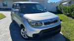 2017 Kia Soul in silver color, parked on a driveway with green grass, showcasing its clean exterior.