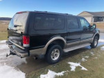 2005 Ford Excursion Eddie Bauer 4WD with low mileage and new tires, parked outdoors.