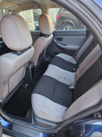 Interior view of 2006 Subaru Impreza showing back seats and clean upholstery, perfect for buyers looking for a reliable car.