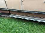 Close-up of the side panel of a 1987 Ford F250 pickup showing rust damage and repair details.
