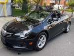2016 Buick Cascada Premium convertible in black with top down, parked on street.