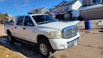2007 Dodge Ram Laramie 3500 Mega Cab 4x4 parked on a street in Colorado Springs, showing its white exterior and chrome details.