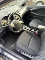 Interior view of a 2009 Toyota Corolla S featuring comfortable seats and modern dashboard controls.