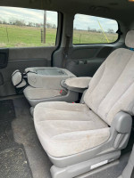 Interior of a 2008 Kia Sedona showcasing spacious seating for a family of seven.