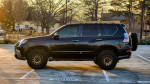 Side view of a modified 2016 Lexus GX460 ready for off-roading, showcasing custom wheels and roof rack.