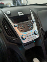 Interior dashboard of a 2011 Chevrolet Equinox showing controls and display features.