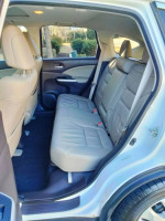 Interior view of a 2014 Honda CRV EX-L AWD showing spacious back seats with beige leather upholstery.
