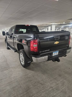 2014 Chevrolet Silverado 2500HD LTZ 4WD in black color parked in a garage with 59000 miles