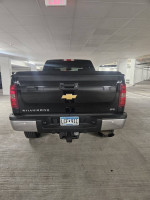 Rear view of a 2014 Chevrolet Silverado 2500HD LTZ 4WD parked indoors, showcasing clean design and license plate.