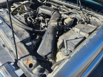 Engine bay of a 1999 Chevrolet Blazer showing components and maintenance details