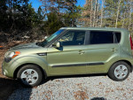 2013 Kia Soul in excellent mechanical condition with 60,000 miles parked on gravel surrounded by trees.
