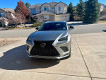 Front view of a 2018 Lexus NX 300 FWD parked in a driveway, showcasing its sleek design and modern features.