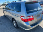2006 Honda Odyssey van for sale with bad transmission, cold AC, and new tires, parked in Ocala, FL.