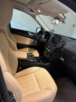 Interior view of a 2017 Mercedes-Benz GLS 450 with beige leather seats and dashboard features