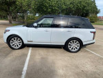 2016 Land Rover Range Rover HSE 4WD in white parked, showcasing its elegant design and spacious SUV body.