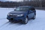 2010 Subaru Forester 2.5X AWD parked in snow, showcasing its all-season capability and new tires.