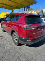 2018 Toyota RAV4 with 137,000 miles parked outside, available for sale - runs and drives well.