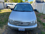 2000 Toyota Sienna XLE minivan parked in yard, showing clean exterior and license plate